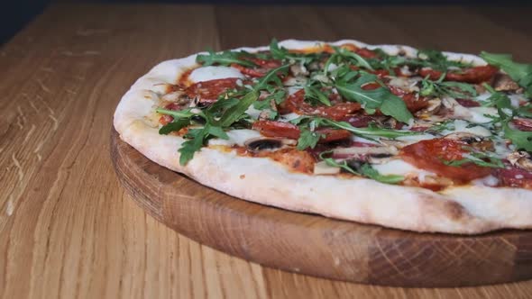 Appetizing Pizza on a Wooden Board in a Restaurant