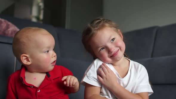 Beautiful Little Boy and Girl Clap Their Hands and Smile. Kid Kissing His Little Sister, Brother and