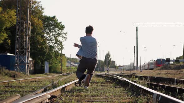 Stylish Male Street Dancer Dancing Near the Railway Tracks