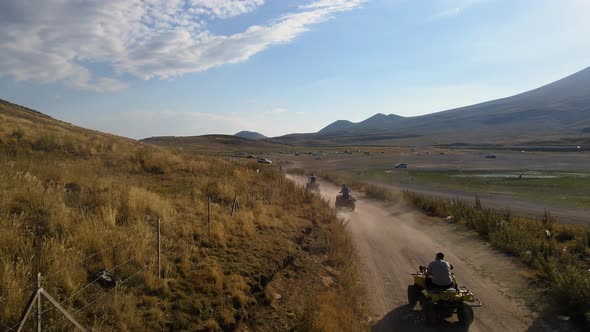 Aerial View From Behind ATVs by Lake and Mountain