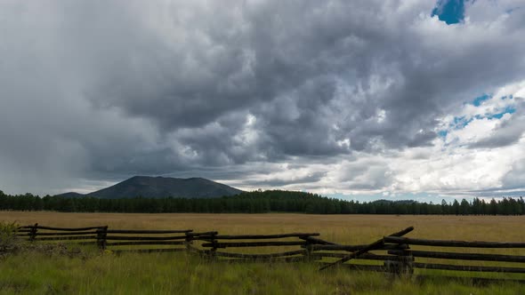 Storm Building Over Meadow and Mountain