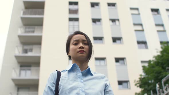 Arc shot of a pensive woman looking at camera