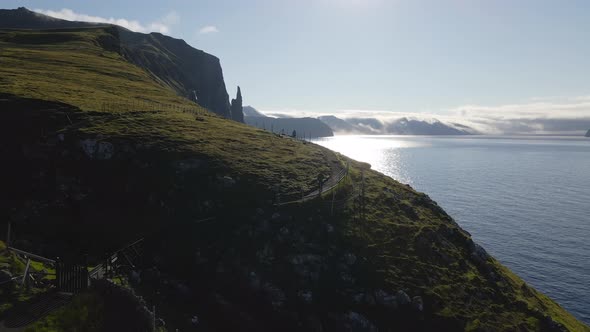 Drone Towards Man Walking Along Coastline Of Vagar