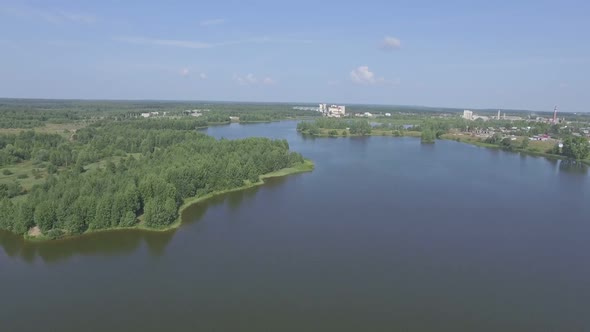 Flying Over The Lake Near Small Town