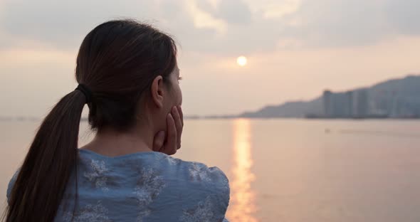 Woman look around the sea view at sunset