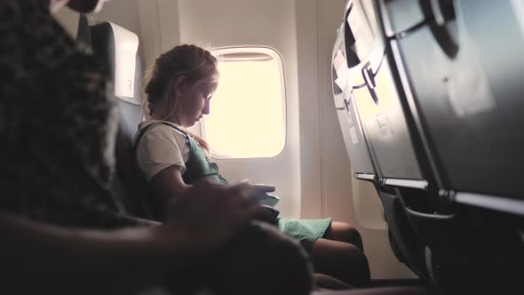 Teen Girl Use of Mobile Phone Inside Airplane