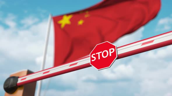 Opening Boom Barrier with Stop Sign Against the Chinese Flag