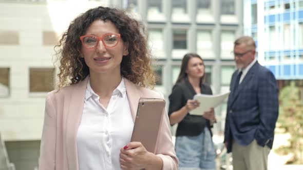 Portrait of a Middleaged Businesswoman in the Courtyard of a Large Business Center