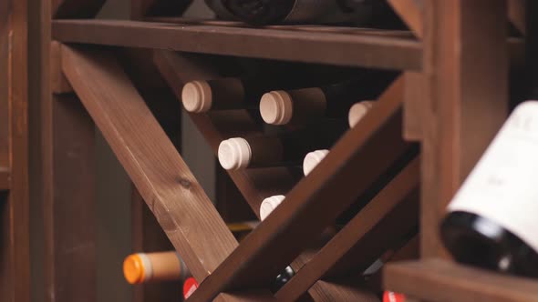 Bottles of Wine Are Stored on Shelves in Cellar of the Wine Shop