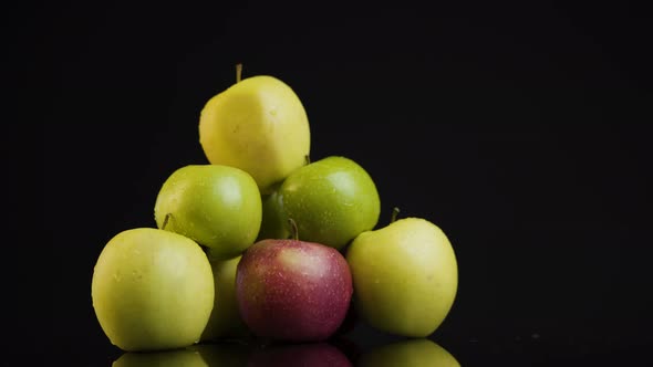 A Pile of Green Apples on A Mirror Top on A Black Background. Surface Reflecting Pile of Apples