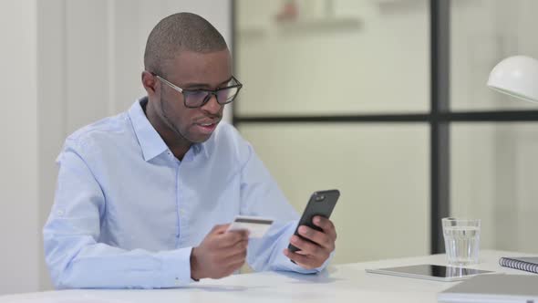 African Man Upset By Online Shopping Failure on Smartphone