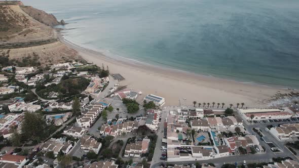 Townhouses by the waterfront, Praia da Luz, Algarve. Beautiful view of emerald sea and horizon.