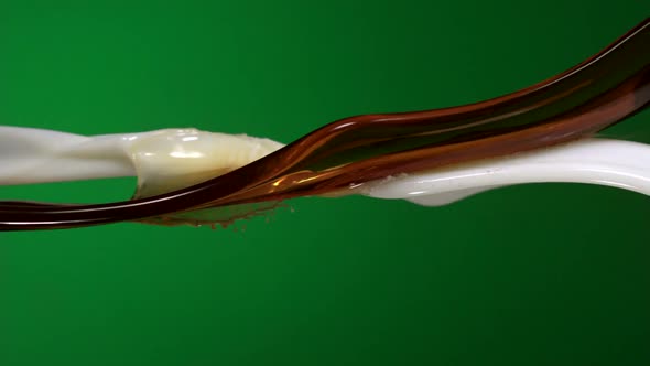 Slow-motion coffee mixed with milk stream