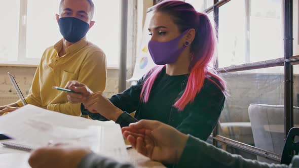 Colleagues Working in Office in Protective Masks Keeping Social Distancing During Consultation Slow