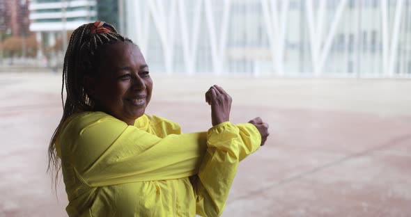 Senior african woman stretching during workout routine outdoor