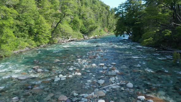 Drone Flight Over Flowing Tree Lined River