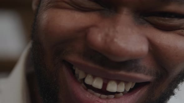 Sincere Smile Laugh of an Adult Africanamerican Man in Extreme Closeup in Slow Motion