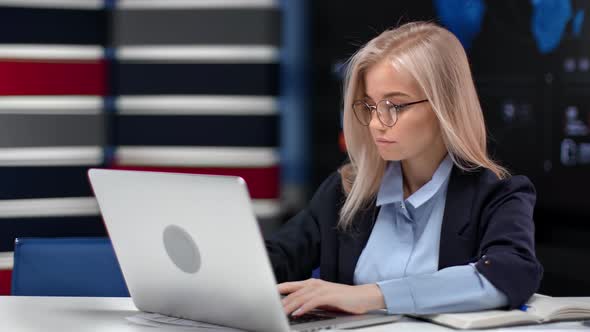 Confident Business Woman Working Use Laptop Pc Sitting at Desk in Innovation Office Workspace