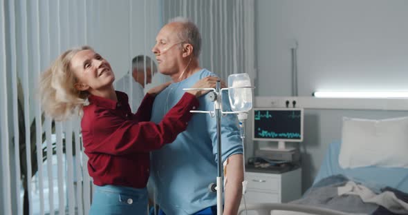 Funny Senior Couple Dancing in Hospital Ward During Visit