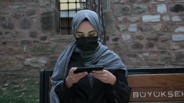 Masked Hijab Woman Showing Green Screen Phone