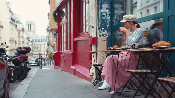 Attractive girl having breakfast in a street cafe