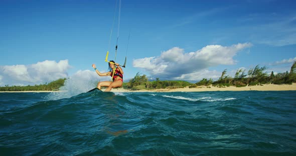 Woman Kiteboarding at Sunset