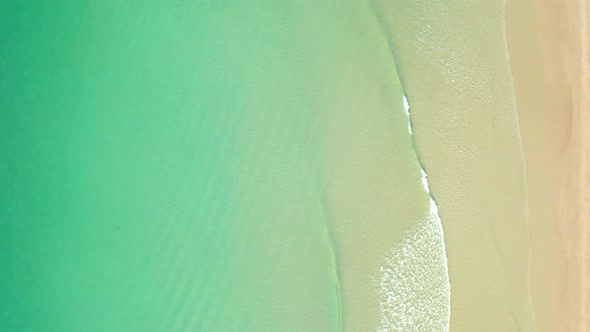 4K Aerial view top view of drone, sea waves and beautiful sand beach.