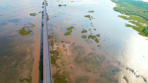 Drone video of the road leads through a large beautiful wetland.