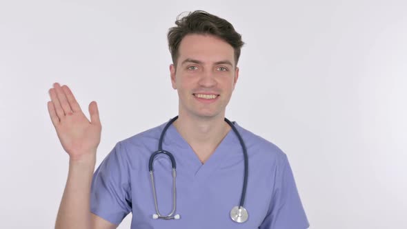 Young Doctor Waving Welcoming on White Background