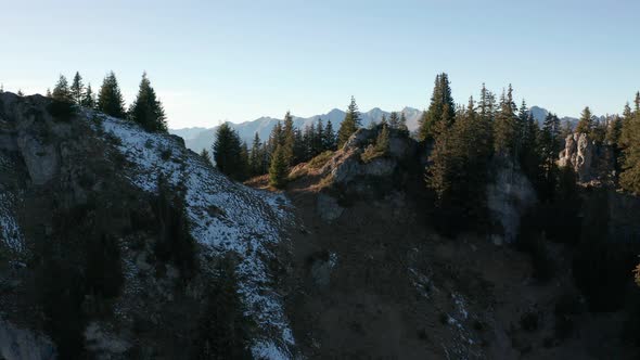 Jib up of mountain top overlooking a beautiful green valley