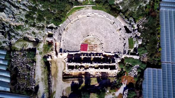 High angle drone aerial view of ancient greek rock cut lykian empire amphitheatre and tombs in Myra