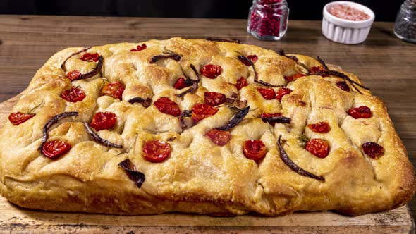 Traditional Italian Focaccia with pepperoni, cherry tomatoes, black olives, rosemary ando onion - ho