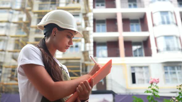 Woman Construction Engineer Wear Safety Hard Hat at Construction Site