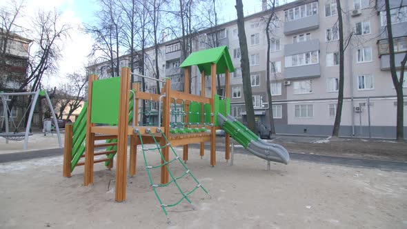 Safe Complex for Children on Sand Playground on Winter Day