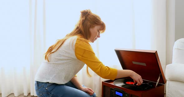 Beautiful woman listening music on turntable 4k