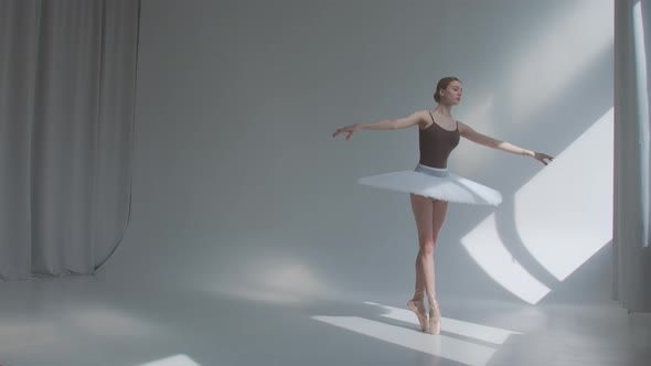 Female Dancer Does Ballet Exercises in Stage Dress with Open Back. Rehearses Dance Moves in the