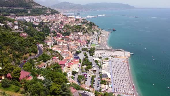 Aerial shot pan forward revealing a city in Amalfi Coast in the Mediterranean Sea