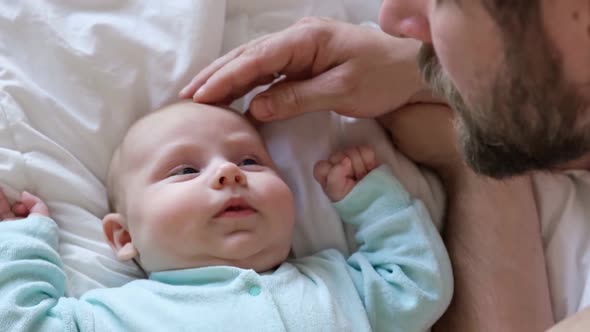 Newborn Baby Smiling and Looking Up at Father