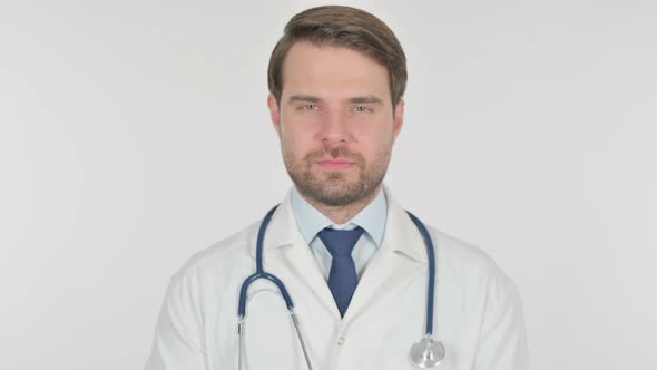 Serious Young Doctor on White Background