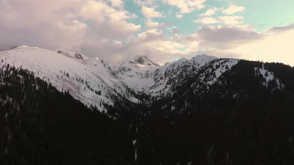 Aerial flight view over snowy mountain