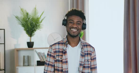 Black-Skinned Guy in Headphones which Standing in front of camera