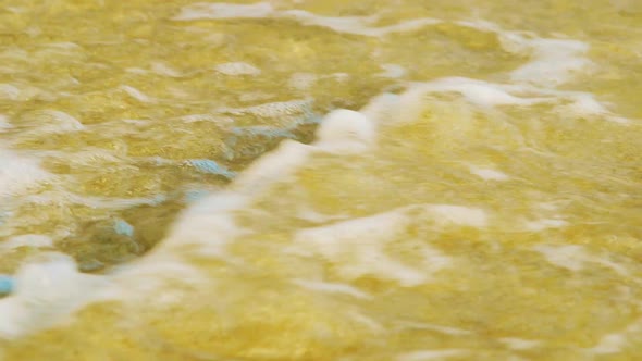 Sea Waves Rolling On The Sandy Beach In Curacao. - close up shot