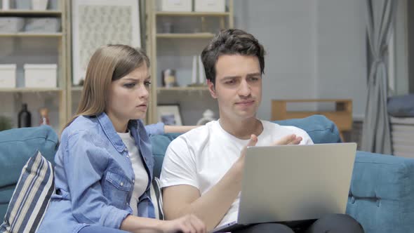 Frustrated Unhappy Young Couple Reacting To Loss on Laptop