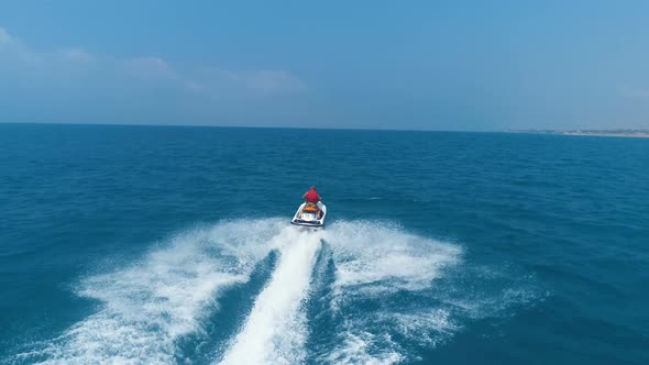 Aerial View Over Man on Jet Ski. Travel Concept. Man Riding on A Jet Ski