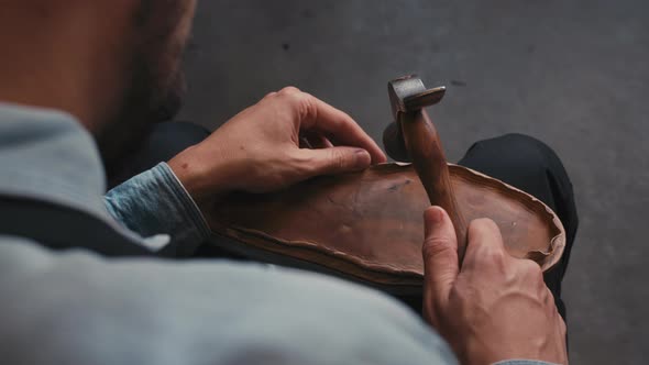 Close Up Shoemaker Taps Sole Shoes with Hammer