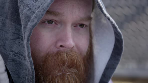 Close up of homeless mans face wearing hoodie