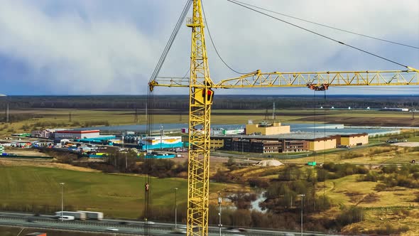 Crane Operates on Construction Site Under Cloudy Sky