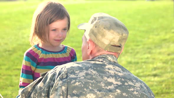 Happy Reunion of EU Soldier with Family Outdoors.