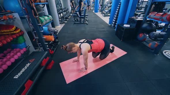 Top view of a woman training on a mat. 