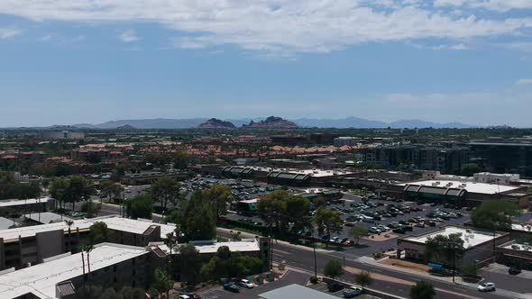Drone footage of a residential and commercial neighborhood in Scottsdale, Arizona with Camelback mou